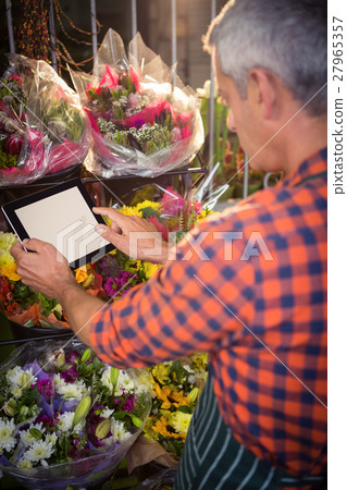 Male florist taking photo of flower bouquet 27965357
