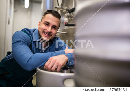 Brewer leaning on keg 27965484