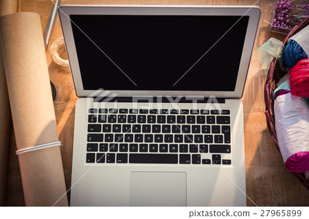 Laptop and florist supplies on the wooden table 27965899