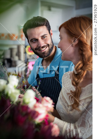 Happy couple arranging flowers 27965929