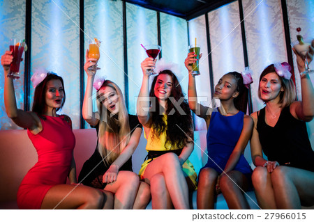Group of happy friends sitting together and showing mocktails 27966015