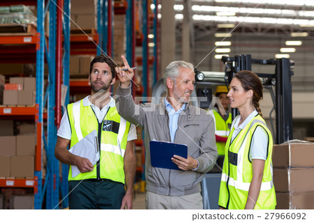 Manager is showing shelves to the workers Manager is showing shelves to the workers 27966092