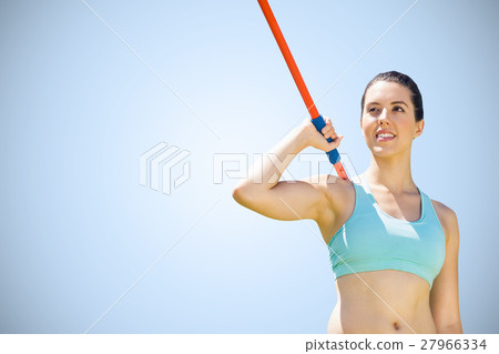 Composite image of woman sporty posing with her javelin 27966334