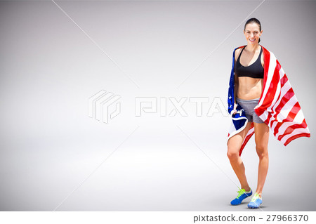 Composite image of sporty woman posing and smiling with american flag 27966370