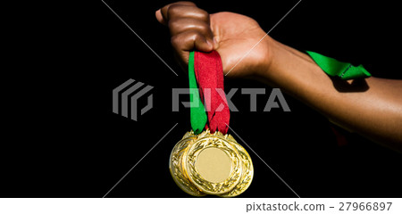 Hand holding three gold medals on white background 27966897
