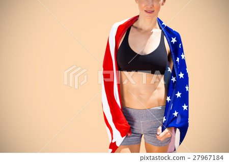 Composite image of sporty woman holding an american flag 27967184