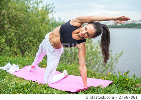 Woman in a yoga pose Woman in a yoga pose 27967861