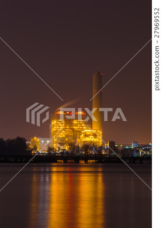 electrical power plant near sea coat at night 27969552