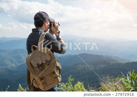 Young professional travrler man with camera  27972918
