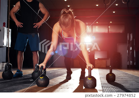 Cute blonde girl doing push ups in gym Cute blonde girl doing push ups in gym 27974852