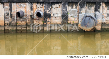 Water discharge pipe  canal in the city 27974901