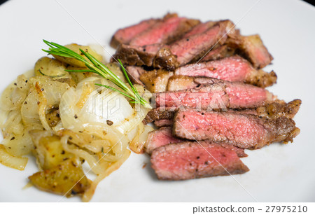 Pink BBQ steak sliced with grilled onion potato Pink BBQ steak sliced with grilled onion potato 27975210