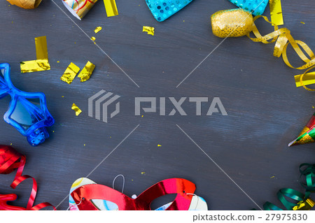 Masquerade decorations on dark wooden background Masquerade decorations on dark wooden background 27975830