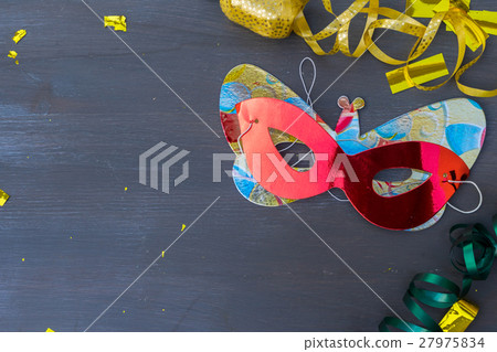 Masquerade decorations on dark wooden background Masquerade decorations on dark wooden background 27975834