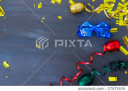 Masquerade decorations on dark wooden background Masquerade decorations on dark wooden background 27975839