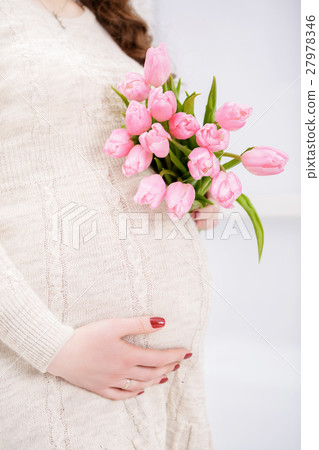 pregnant woman with bouquet of tulips touch bell pregnant woman with bouquet of tulips touch bell 27978346