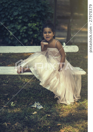 little girl in a pink ballroom dress on nature 27978379