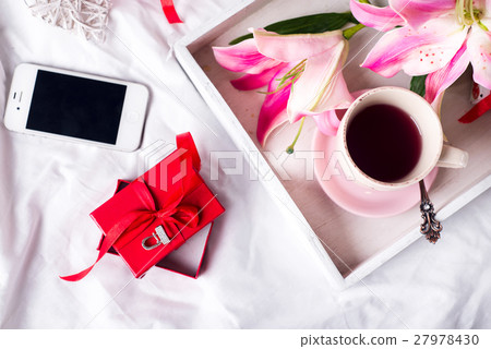 tray with cup of hot tea in the bed, 27978430