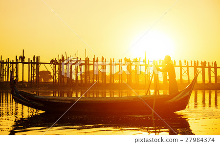 Fishman under U bein bridge at sunset Fishman under U bein bridge at sunset 27984374