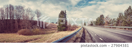 black asphalt road on sunny spring da 27984381