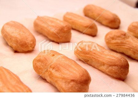 Long rows Eclair shells. Eclairs candy paper.  27984436
