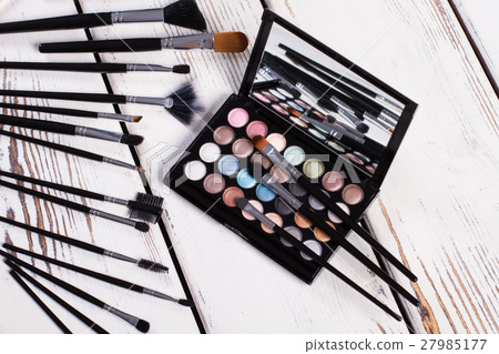 Set of natural brushes and eye shadow palette. Set of natural brushes and eye shadow palette. 27985177