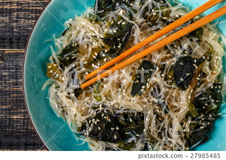 Funchoza salad with wakame on dark background. 27985485