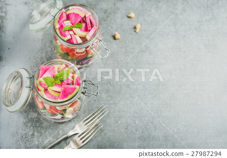 Healthy vegetarian salad in jars over grey Healthy vegetarian salad in jars over grey 27987294
