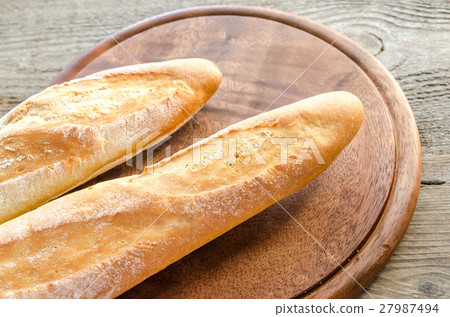 Two baguettes on the wooden tray 27987494