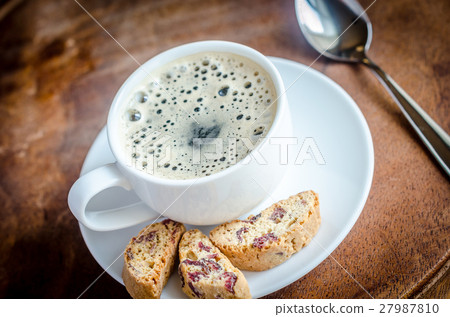 A cup of coffee with biscotti 27987810
