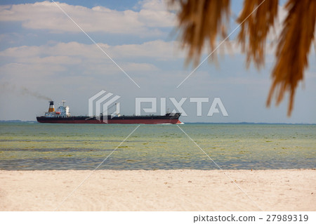 Oil Tanker Sailing Past Tropical Beach and Palm Tree 27989319