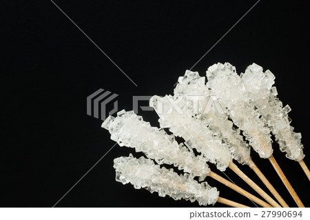 Crystallized sugar on wooden stick. Crystallized sugar on wooden stick. 27990694