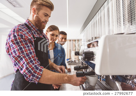 People trying to make coffee People trying to make coffee 27992677