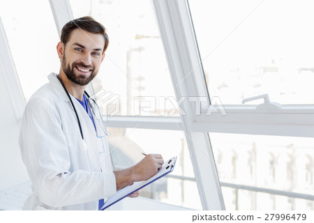 Doctor writing down good results of treatment Doctor writing down good results of treatment 27996479