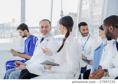 Medical team talking in clinic Medical team talking in clinic 27997239