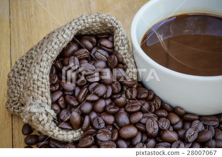 Hot coffee on the wood and roast coffee bean. Hot coffee on the wood and roast coffee bean. 28007067