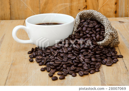 Hot coffee on the wood and roast coffee bean. Hot coffee on the wood and roast coffee bean. 28007069