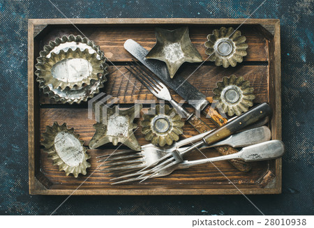 Old vintage tin baking molds and cutlery in wooden 28010938