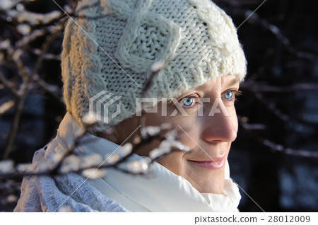 blue-eyed woman in white in the winter forest.  28012009