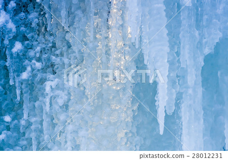 blue ice and frozen icicles, winter background blue ice and frozen icicles, winter background 28012231