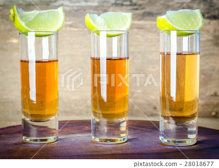 Glasses of tequila on the wooden board 28018677