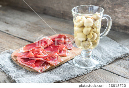 Slices of jamon on the wooden board Slices of jamon on the wooden board 28018720