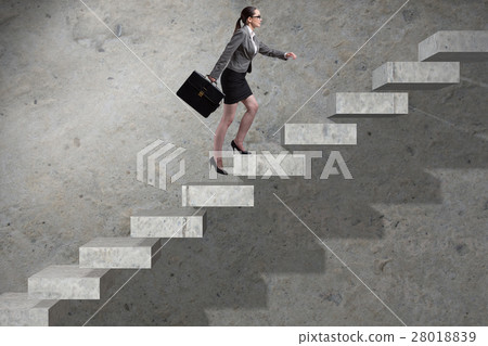 Young businesswoman climbing career ladder Young businesswoman climbing career ladder 28018839