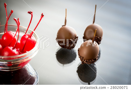 Chocolate and cocktail cherries on the glass 28020071