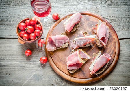 Sandwiches with italian ham on the wooden board Sandwiches with italian ham on the wooden board 28020167