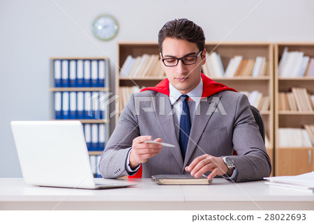 Superhero businessman working in the office Superhero businessman working in the office 28022693