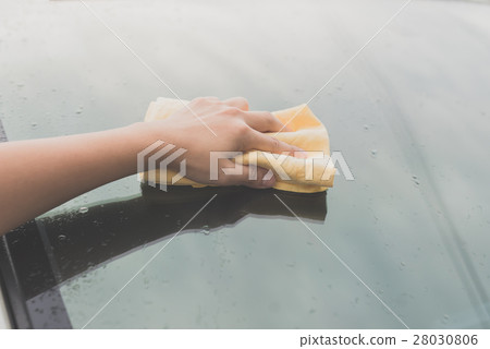woman washing car window with microfiber cloth 28030806