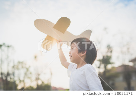 Cute Asian child playing cardboard airplane Cute Asian child playing cardboard airplane 28031171