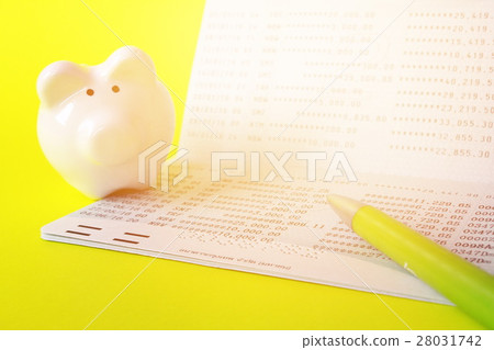 Passbook, piggy bank, pen on yellow background Passbook, piggy bank, pen on yellow background 28031742