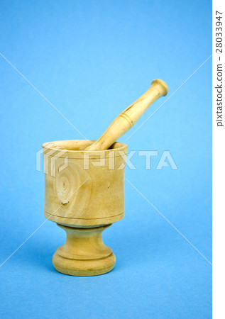 wooden mortar with pestle on blue background 28033947